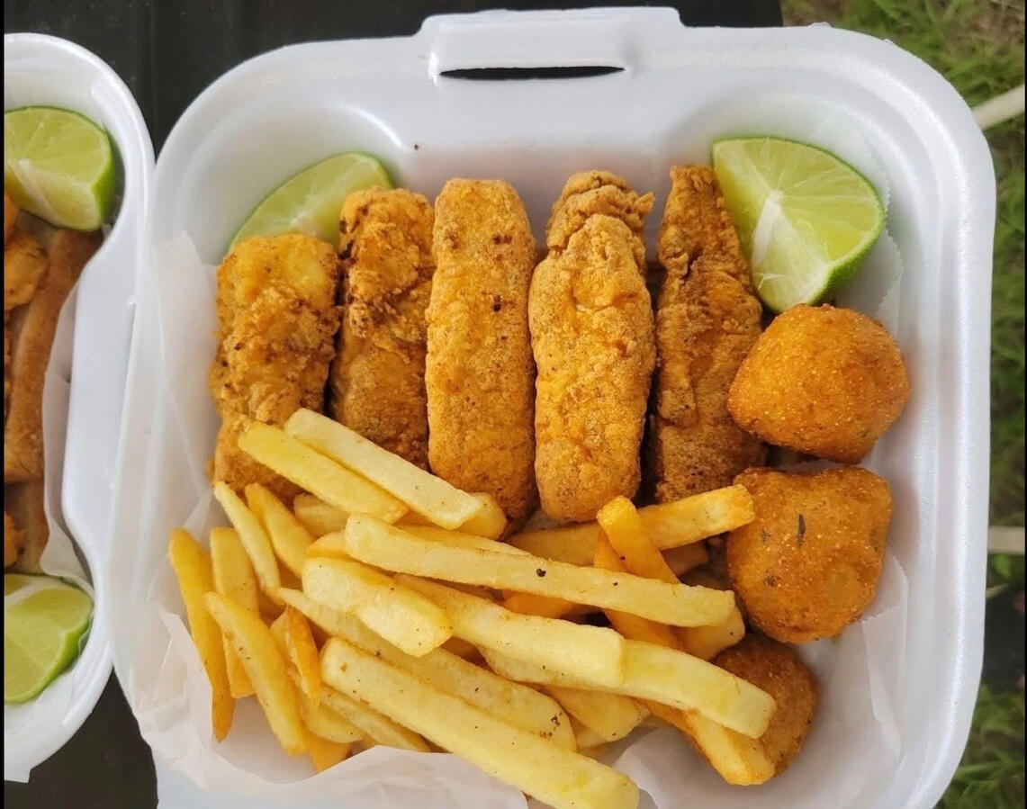 Aunt Lily’s Kitchen & Catering tilapia fish, fries, and hush puppies.